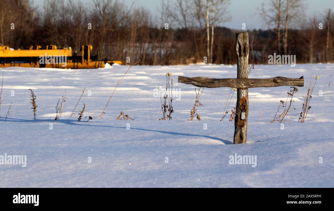 Cross in the snow Stock Photo