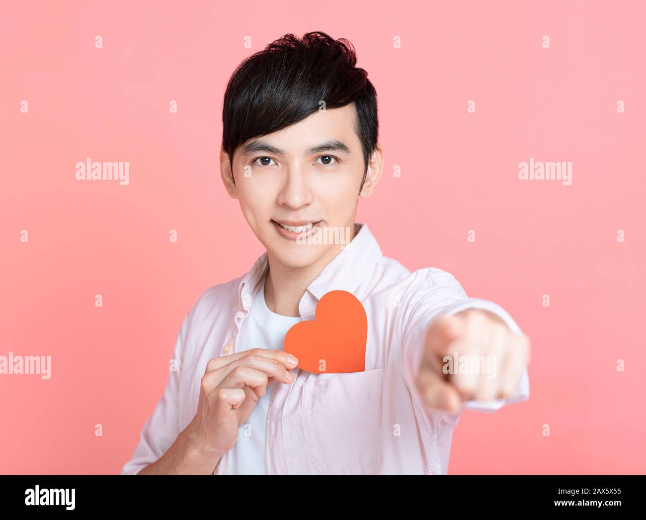 Happy young man  showing red paper hearts  and celebrating  valentines day Stock Photo