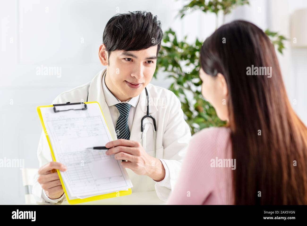 doctor explaining medical reports to his patient Stock Photo