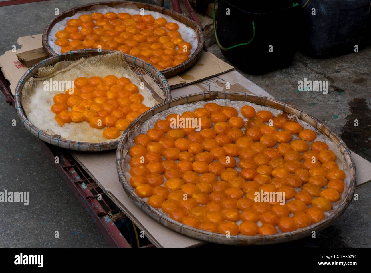 Orange duck egg yolks in the winnow basket, Tai O village, Hong Kong Stock Photo