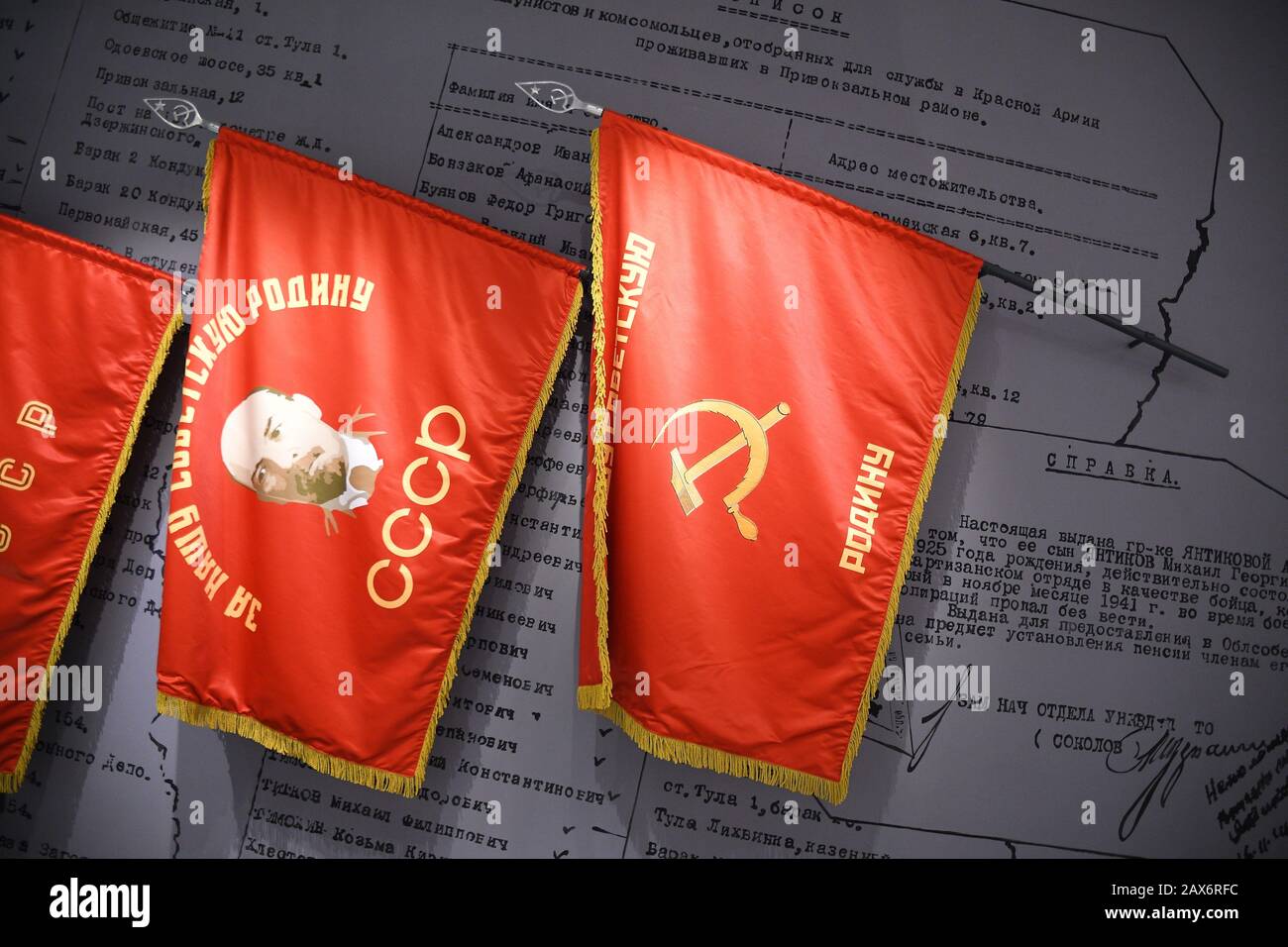 High angle shot of three red historical flags on a document Stock Photo