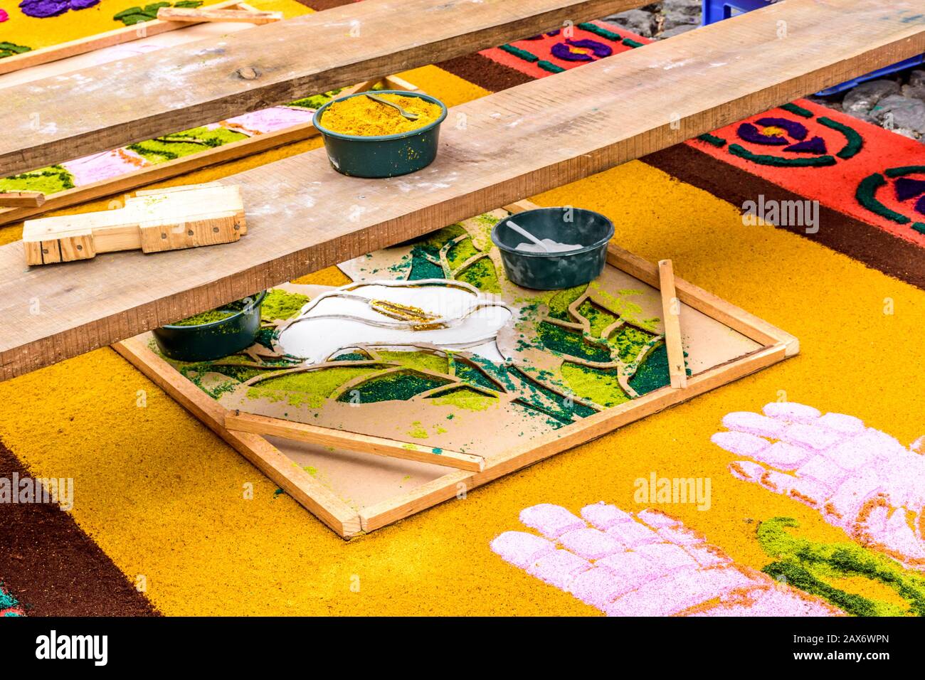 Antigua, Guatemala -  April 13, 2017: Making dyed sawdust Holy Week procession carpet in UNESCO World Heritage Site with famed Holy Week celebrations. Stock Photo