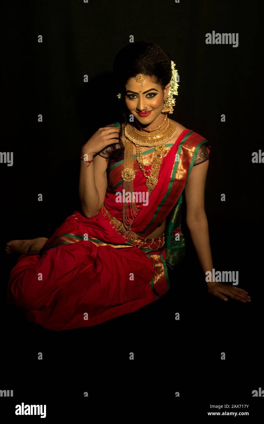 Beautiful Indian Marathi bride in red saree wearing jewelry Stock ...