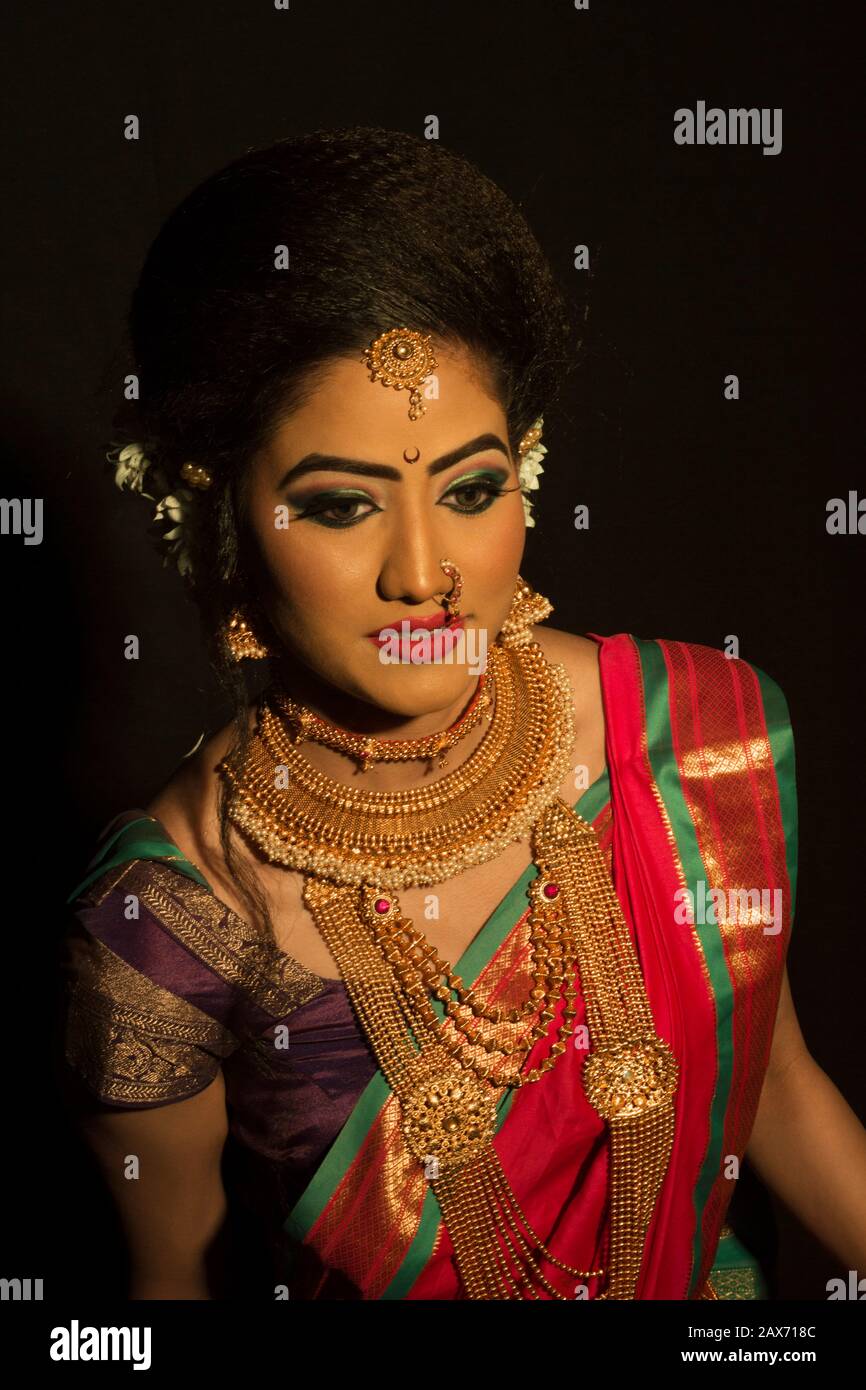 Beautiful Indian Marathi bride in red saree wearing jewelry Stock ...