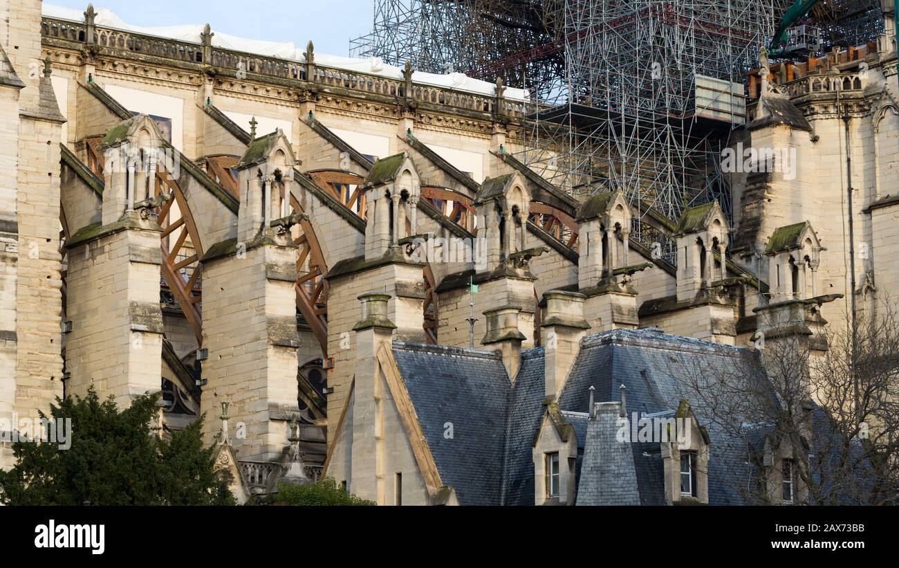 View on the flying buttresses of Notre Dame. The catholic cathedral was heavily damaged during a fire on April 19, 2019. With melted scaffolding. Stock Photo
