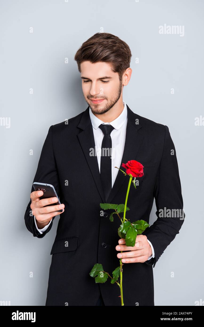 Happy man with rose waiting for his girlfriend and reading sms Stock Photo  - Alamy