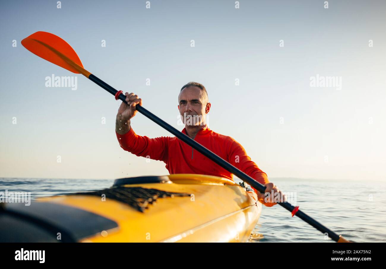 Active senior man paddling kayak. Enjoy sea kayaking Stock Photo