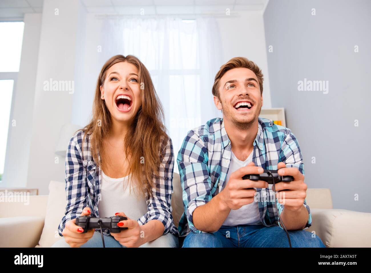 Portrait of happy excited family playing video games Stock Photo