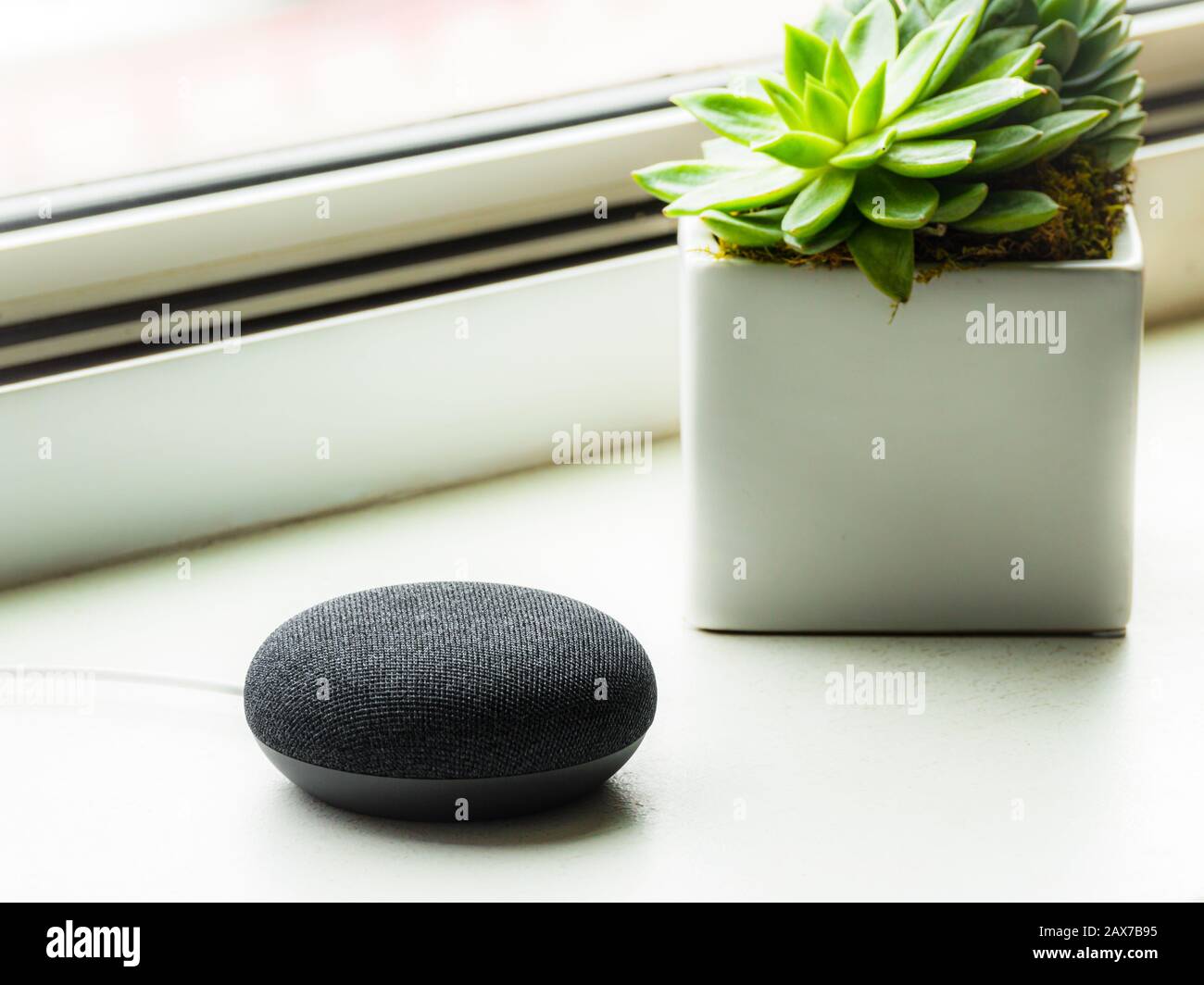 A charcoal black smart speaker at home. Smart home technology. Stock Photo
