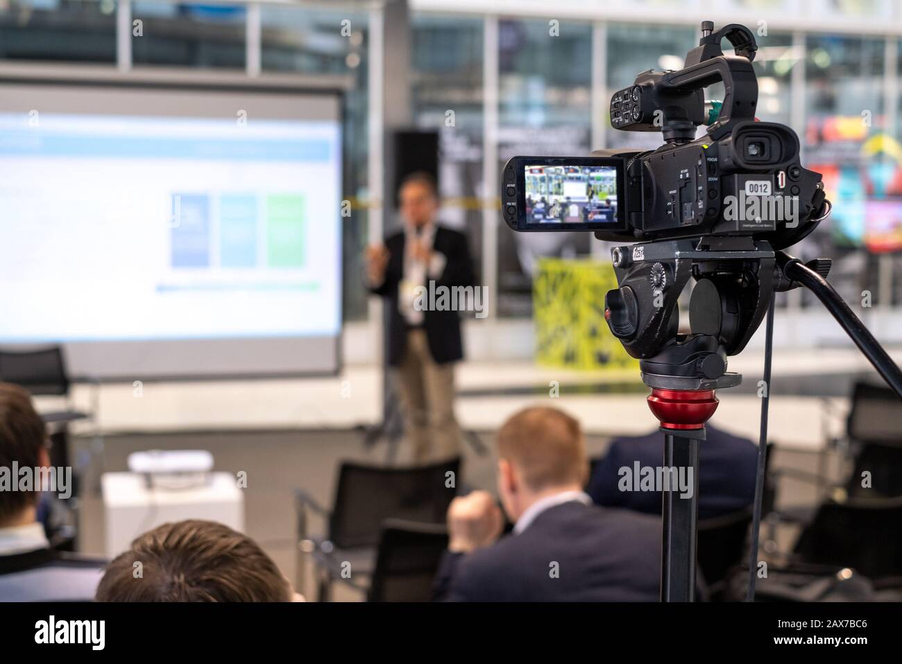 Still camera recording male speaker in conference hall Stock Photo Alamy