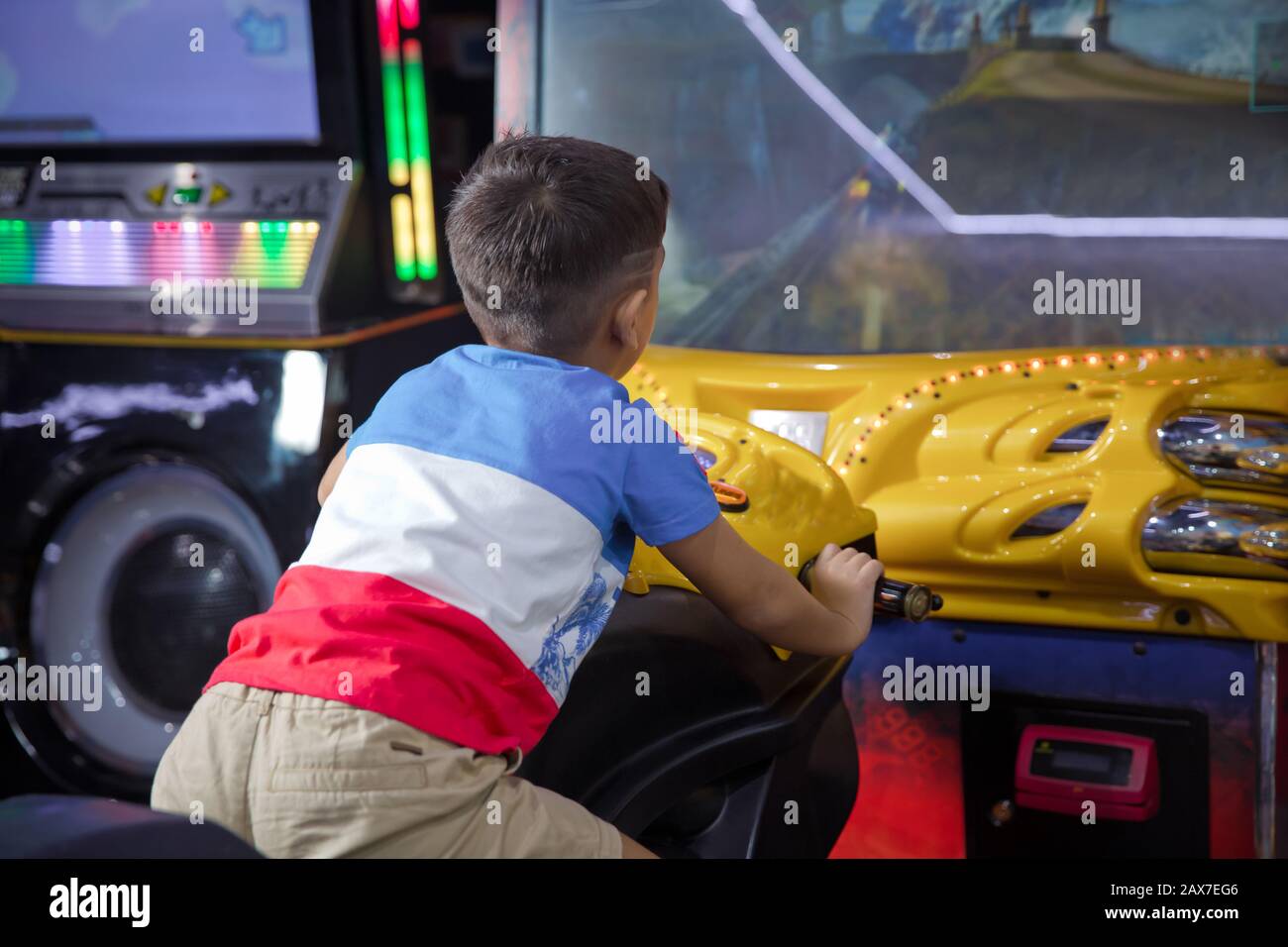 kid boy playing arcade video game. Motorcycle Racing . Kid playing  motorbike simulator . boy on a children's computer motorcycle, a gaming  machine for Stock Photo - Alamy