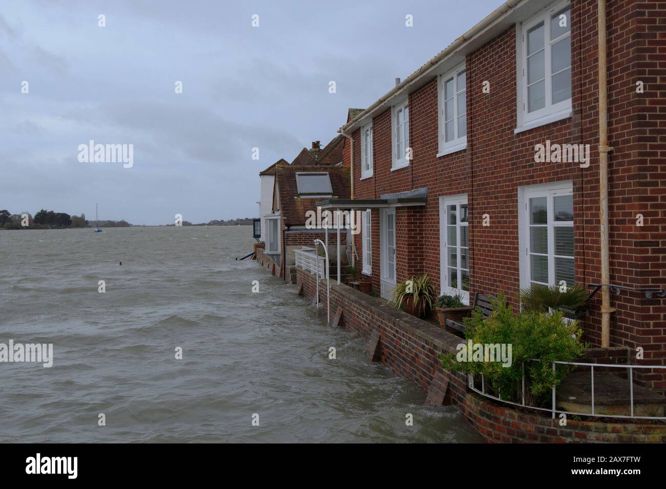 Bosham, West Sussex. 10th Feb 2020. UK Weather: Homes are surrounded by water as tides rise in the wake of Storm Ciara and flood the village of Bosham, West Sussex, Uk Monday February 10, 2020. Many places in the UK remain with yellow weather warnings as the Storm Ciara weather front continues. Photograph : Luke MacGregor Credit: Luke MacGregor/Alamy Live News Stock Photo