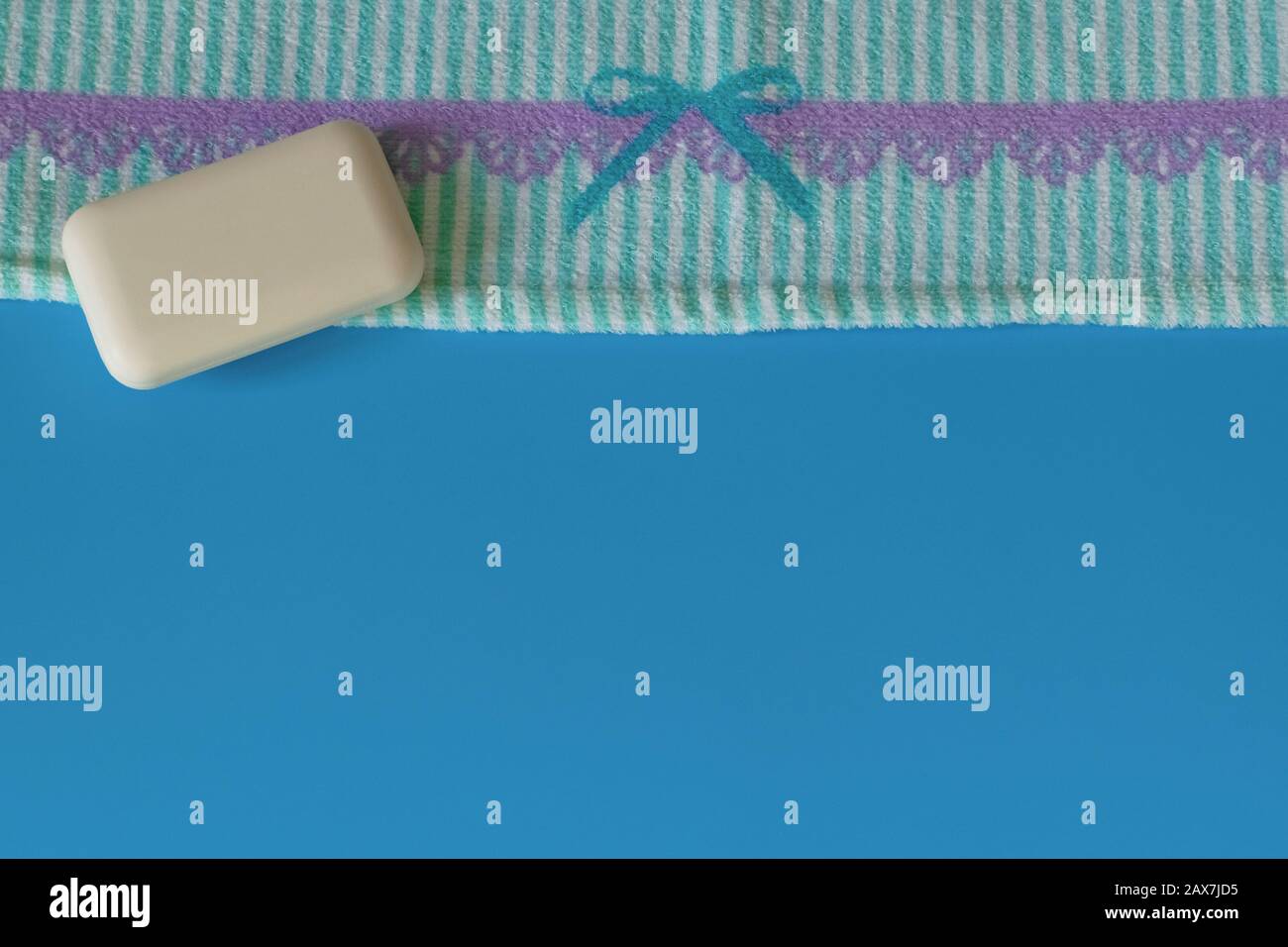 Soft and fluffy towels on a blue background. Soap for bath, laundry and body care. Personal