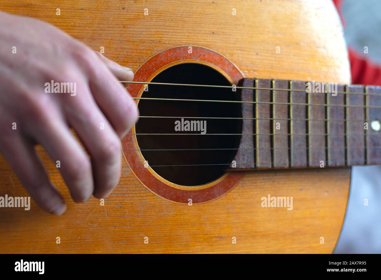 play with fingers fingering strings on a classic acoustic guitar. live music concept. Stock Photo