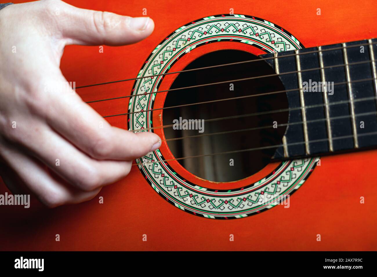 play with fingers fingering strings on a classic acoustic guitar. live music concept. Stock Photo