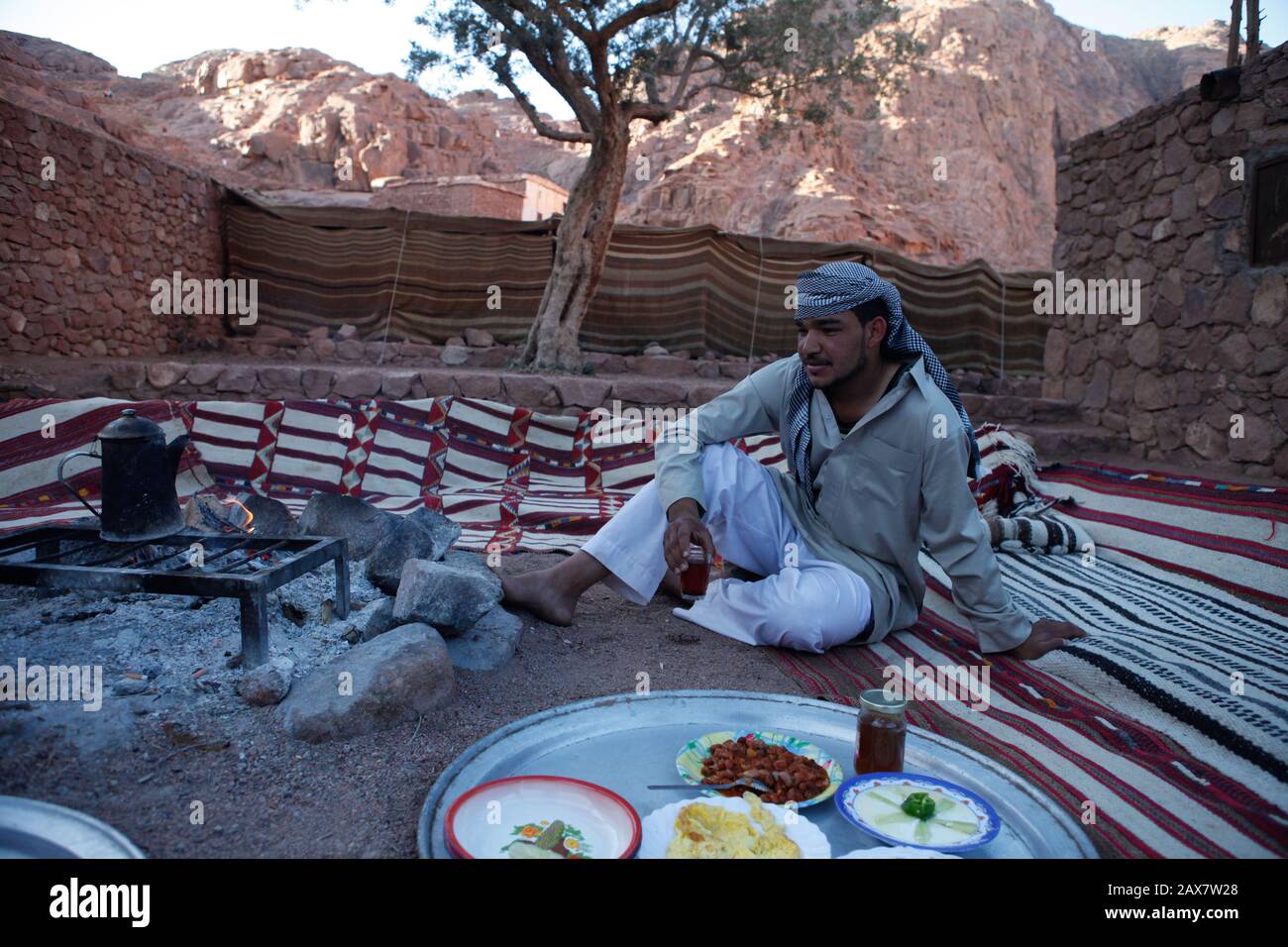 A Bedouin sips tea under the pinnacle of Mt. Sinai Stock Photo Alamy