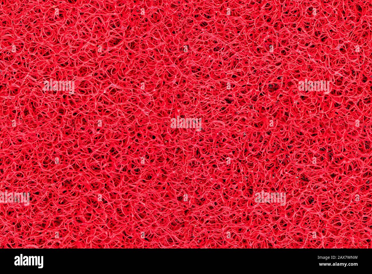 https://c8.alamy.com/comp/2AX7WNW/close-up-detail-bright-red-plastic-doormat-seamless-texture-neutral-abstract-backdrop-surface-2AX7WNW.jpg