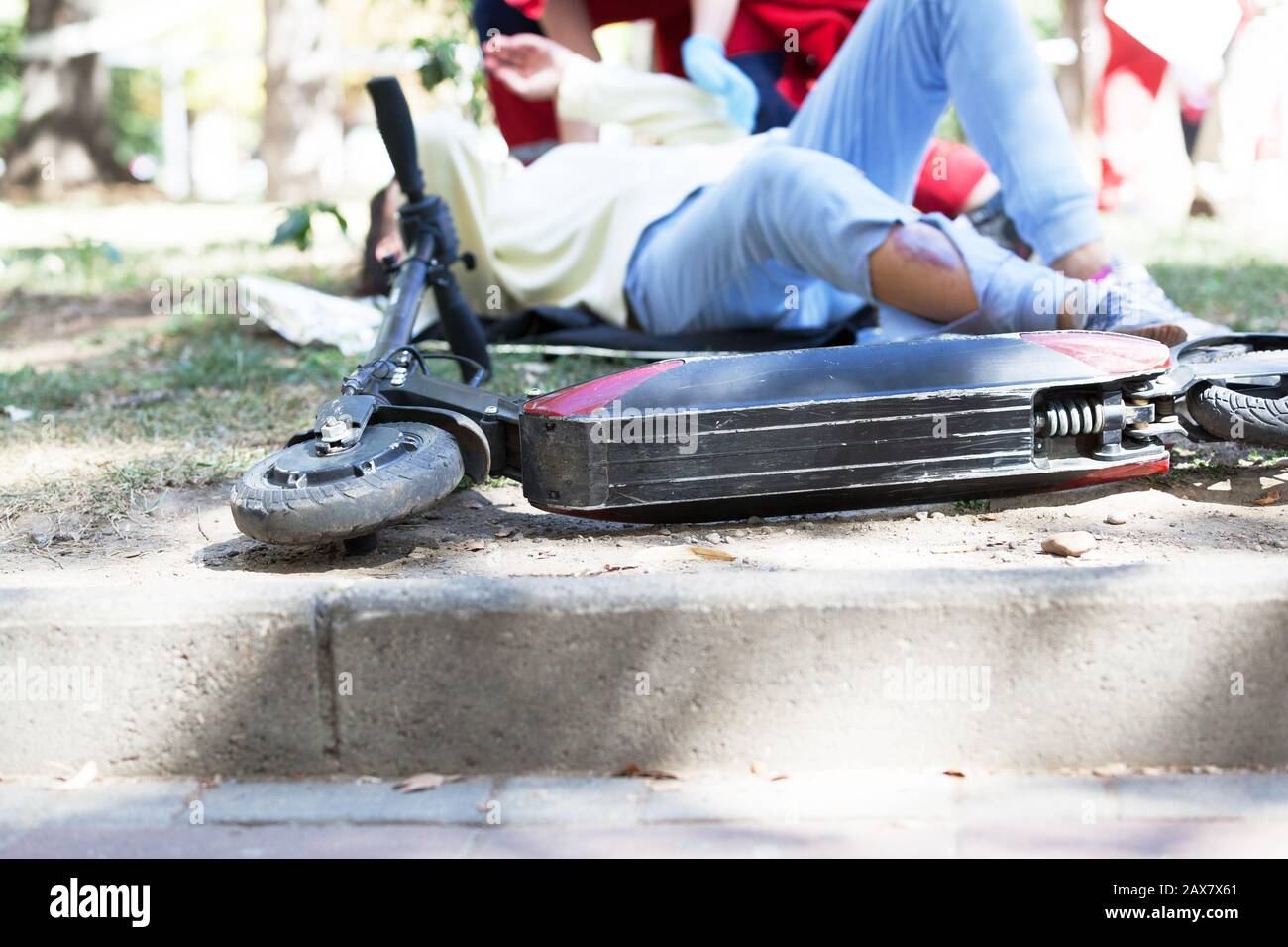 First aid after electric scooter accident Stock Photo