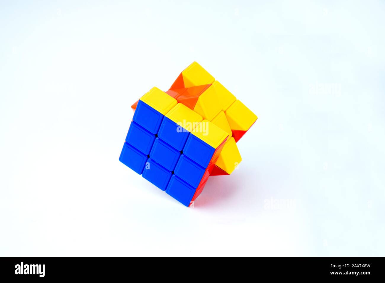 A nice rubik cube which is solved is displayed on an isolated white background Stock Photo