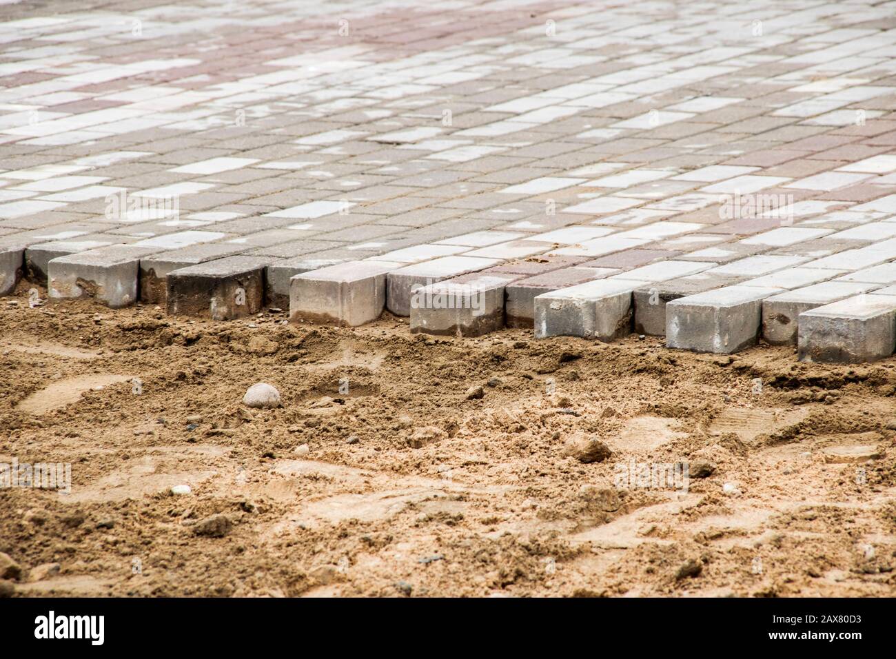 Laying of paving slabs on sand, repair and construction on the street Stock Photo Alamy