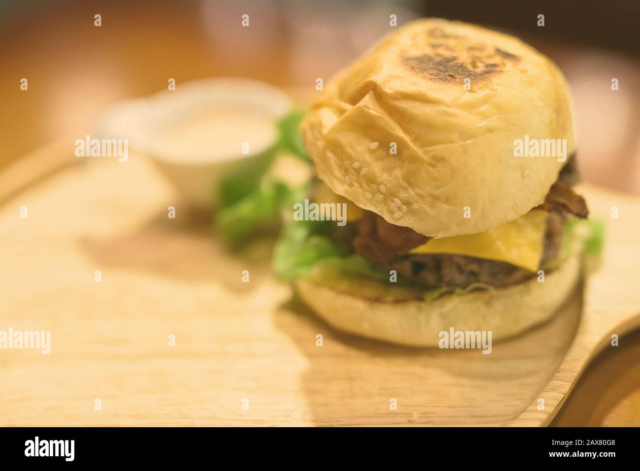 Portrait Of Cheeseburger Served On Wooden Table Stock Photo