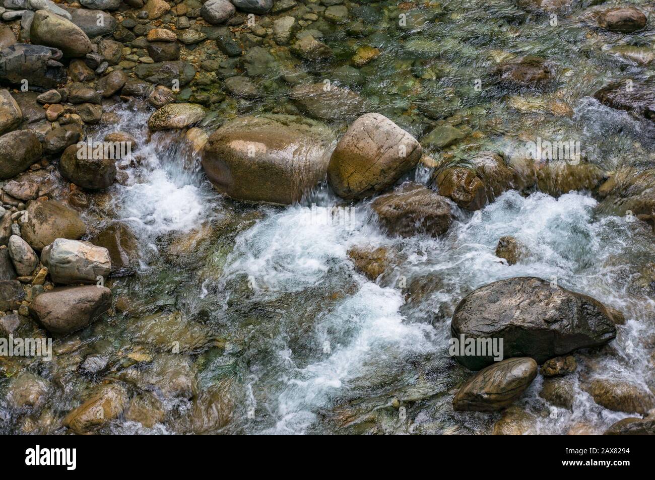 water rapidly flowing over rocks. Mountain stream close up Stock Photo