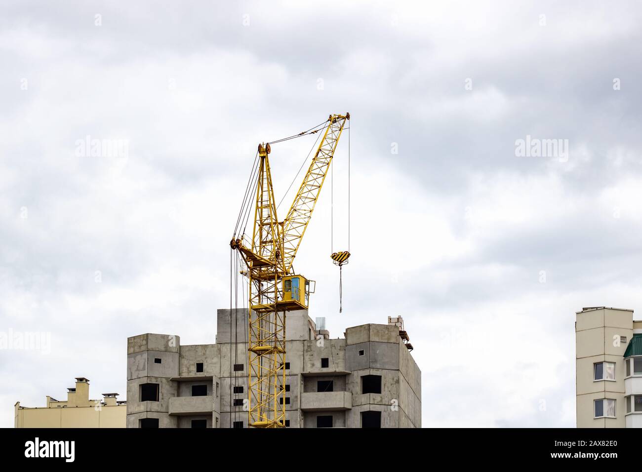 Construction crane against a cloudy sky background Stock Photo - Alamy