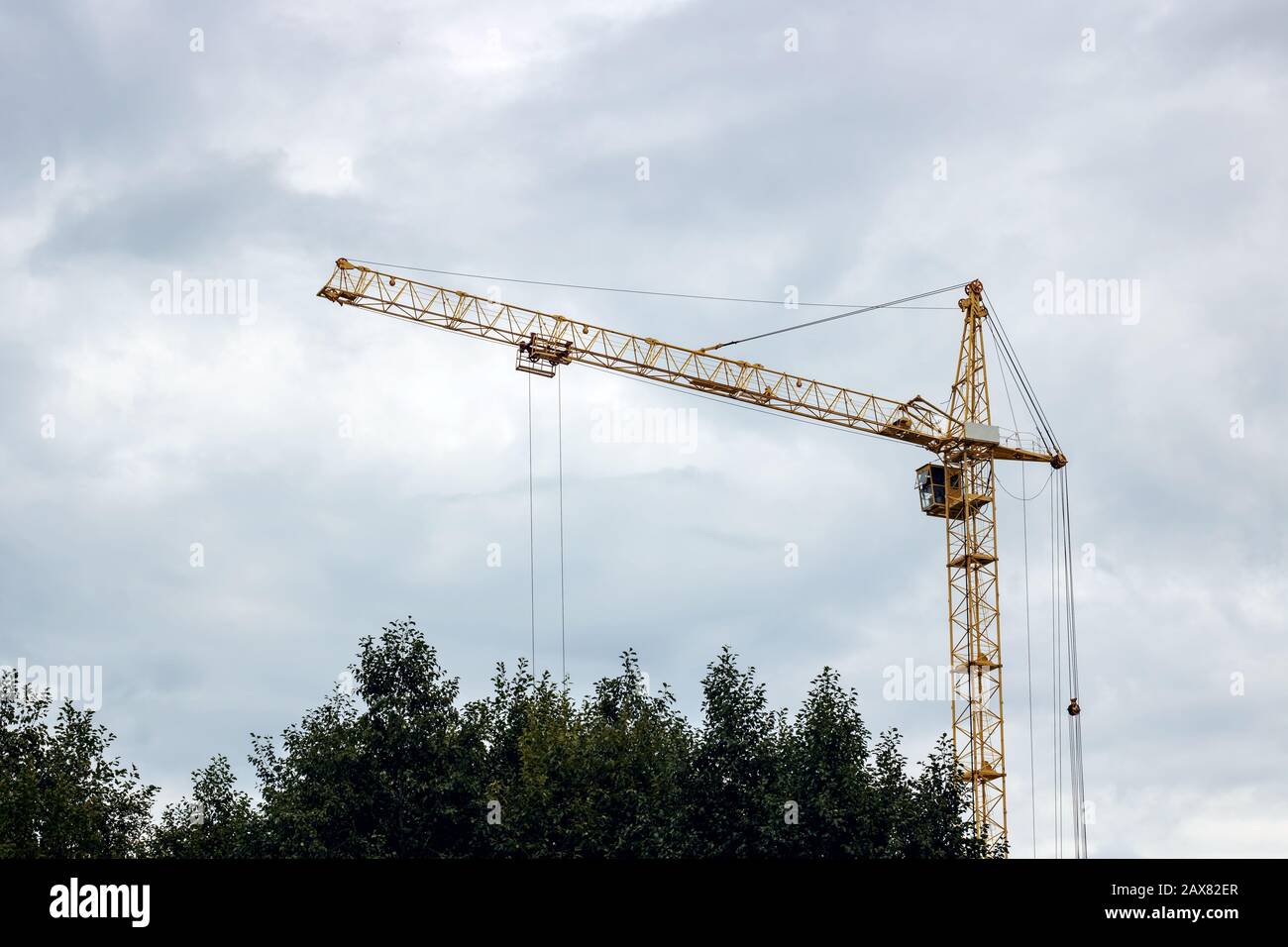 Construction crane against a cloudy sky background Stock Photo - Alamy