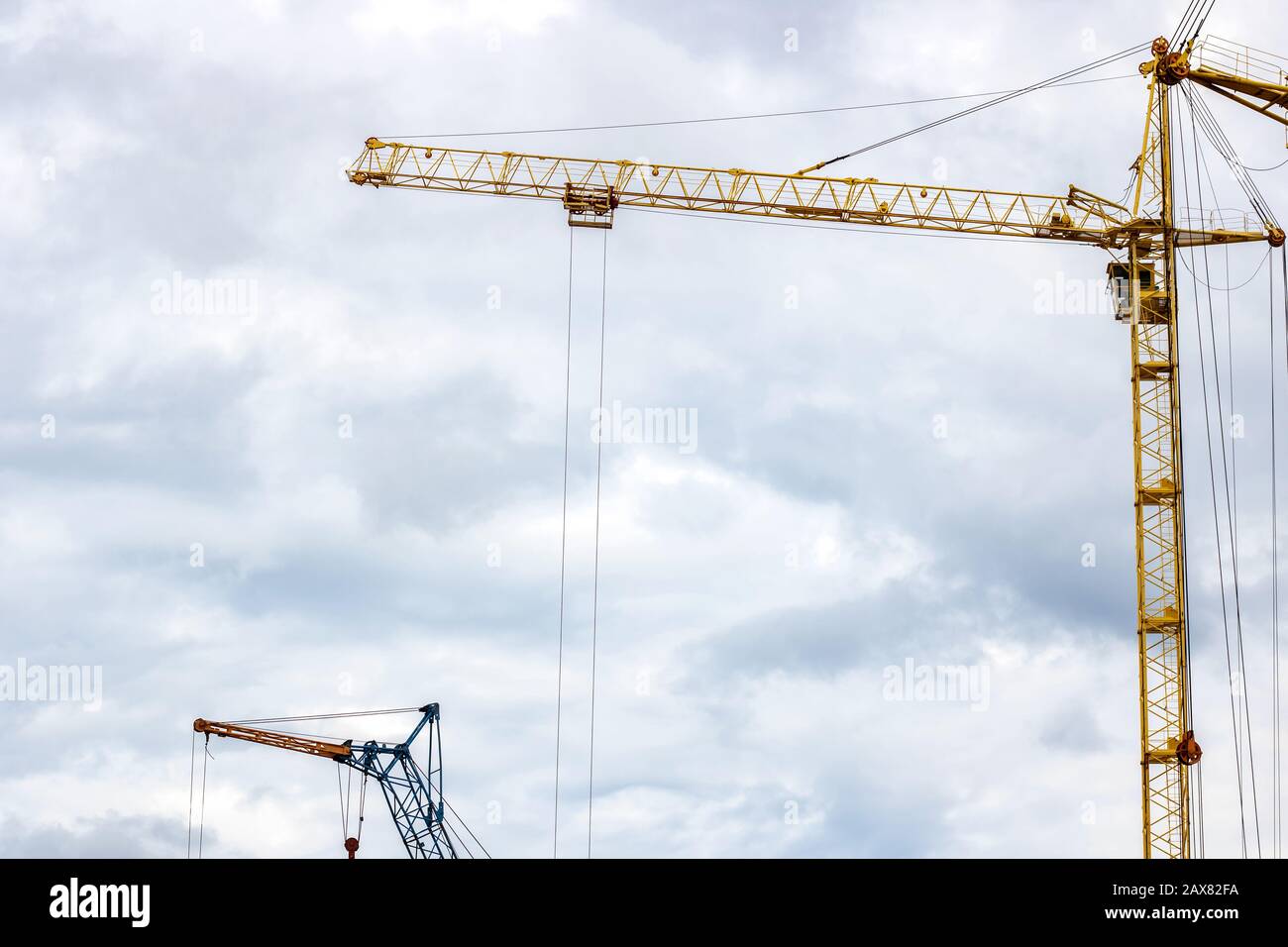 Construction crane against a cloudy sky background Stock Photo - Alamy