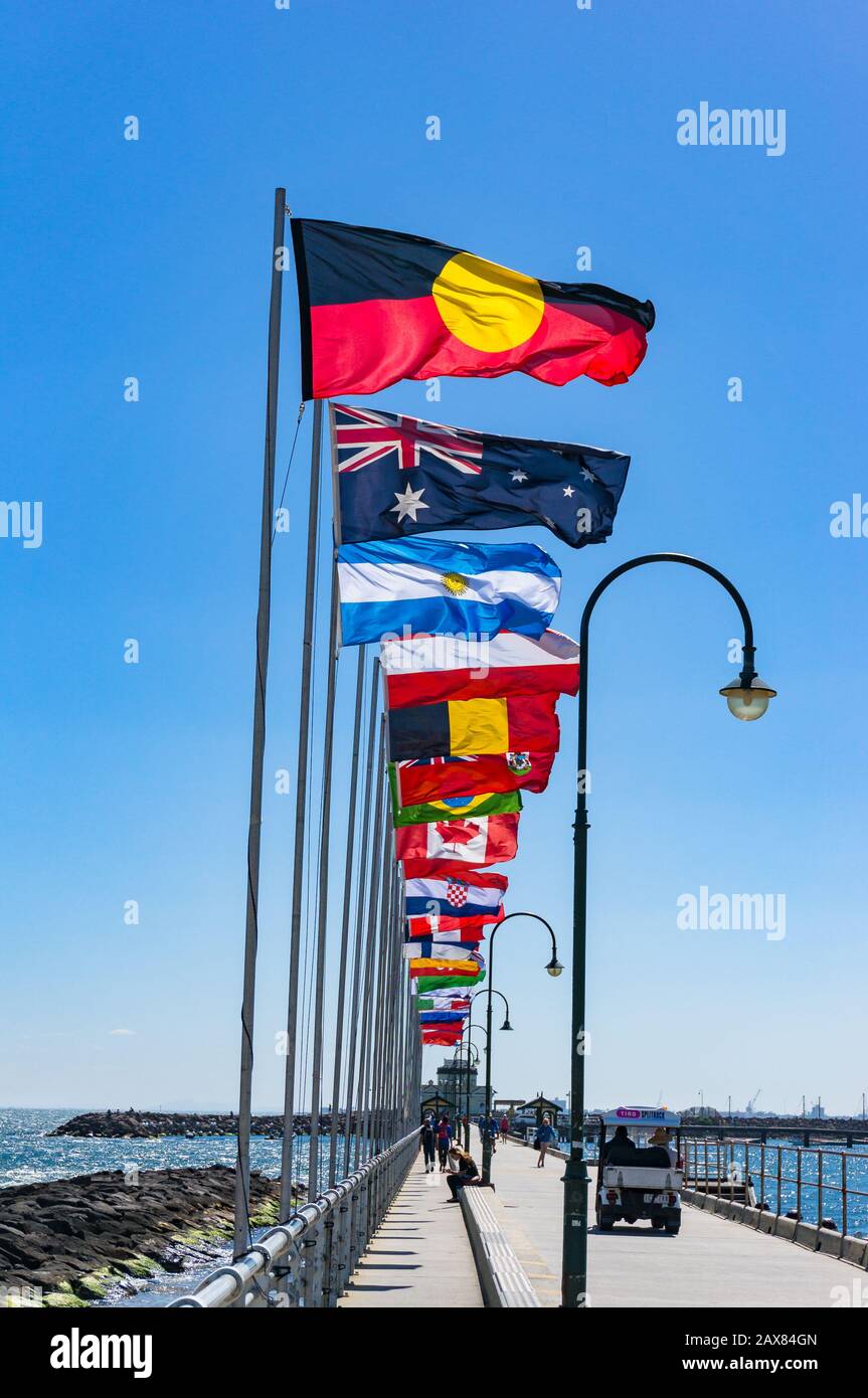 Melbourne, Australia - December 7, 2016: St Kilda Pier with rows of national flags with Australian Aboriginal flag Stock Photo