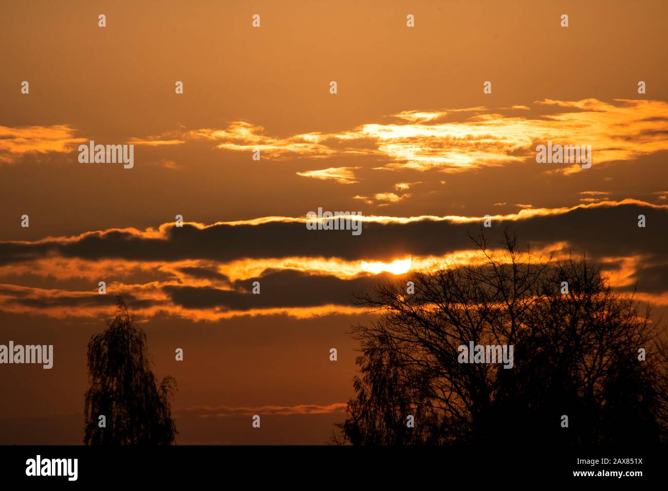 Sun in the red sky at sunrise Stock Photo - Alamy