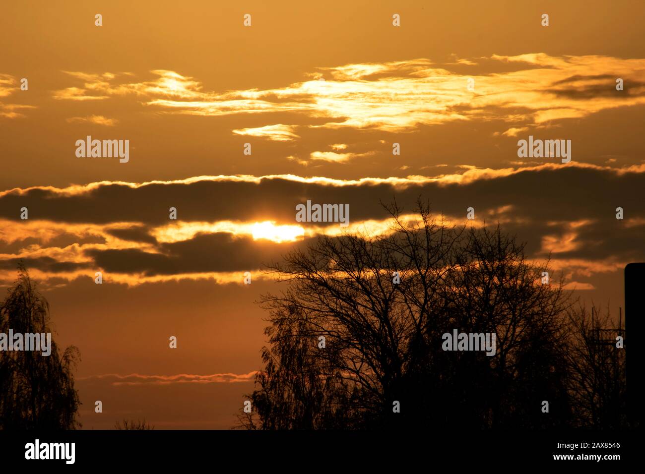Sun in the red sky at sunrise Stock Photo - Alamy