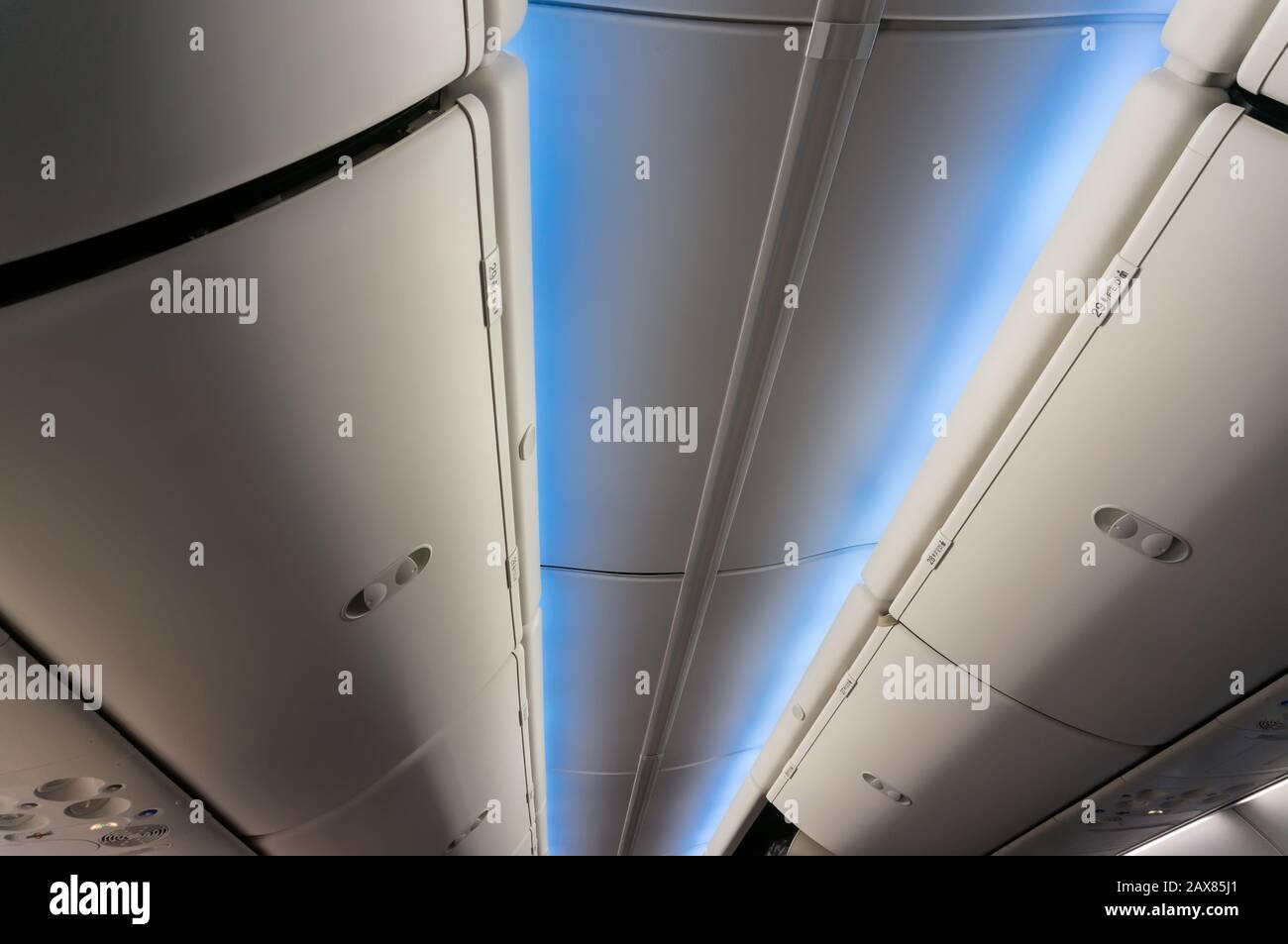 Interior lighting and luggage racks in a passenger plane Stock Photo
