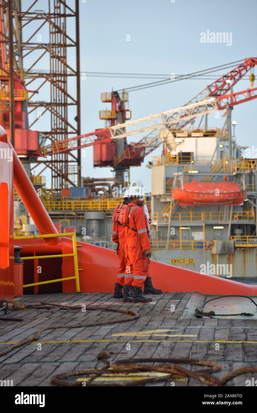 Marine crew commencing  anchor handling operation on deck for jack up rig Stock Photo