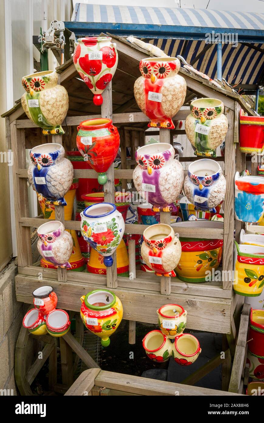 A display of painted ceramic wall-planters for sale in an English garden centre in Devizes Wiltshire England UK Stock Photo