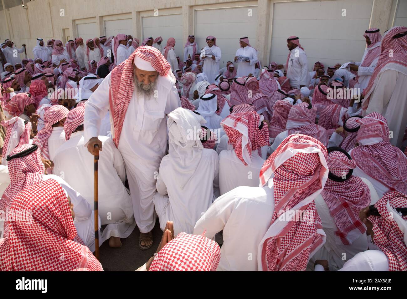 Once a week hundreds of men line up and wait with their papers for money donation for HRH Prince Al Waleed bin Talal, Saudi Arabia. Stock Photo