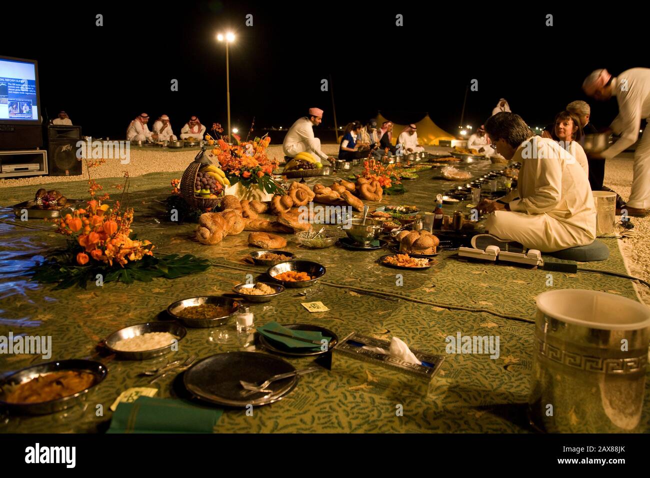 HRH Prince Al Waleed Bin Talal sits down for dinner at his desert camp outside Riyadh, Saudi Arabia. Stock Photo