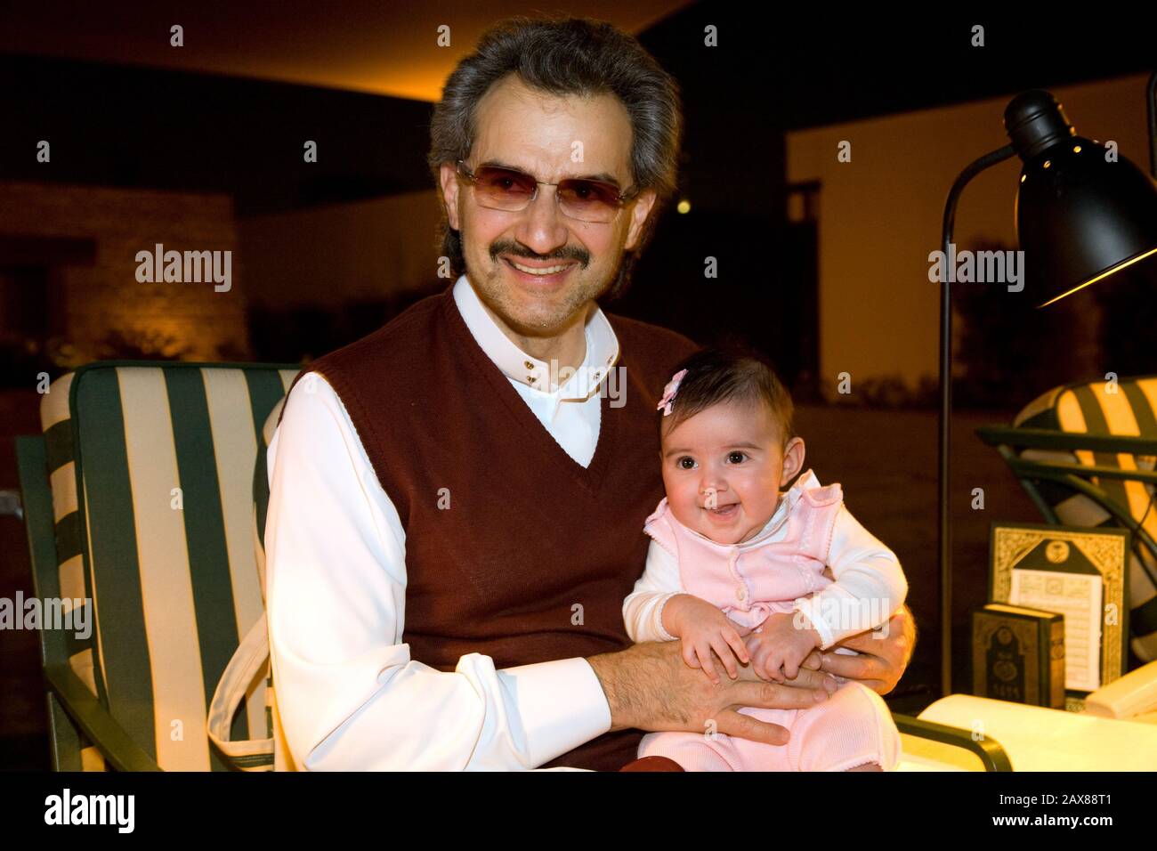 His Royal Highness Prince Al Waleed Bin Talal Al-Saud enjoys sometime with his granddaughter Sarah at his Palace, Riyadh, Saudi Arabia. Stock Photo