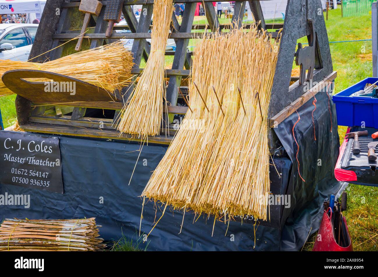 Taking a break from a demonstration of thatching at the Heddington Steam Fair and Country Show in Wiltshire England UK Stock Photo