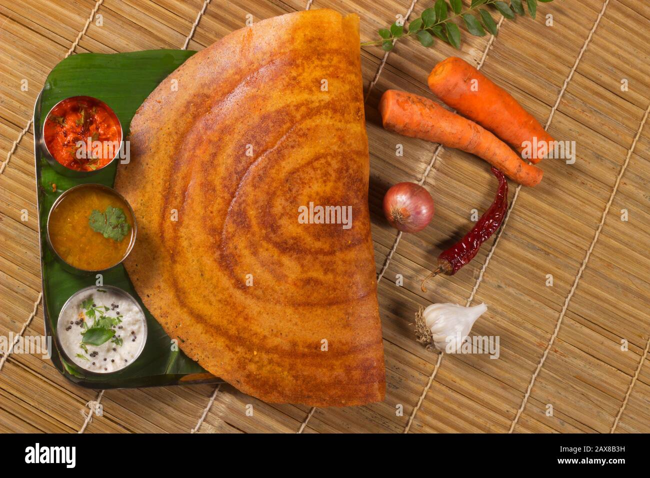 Paper Dosa with sambar and coconut chutney. South Indian Vegetarian Snack Stock Photo
