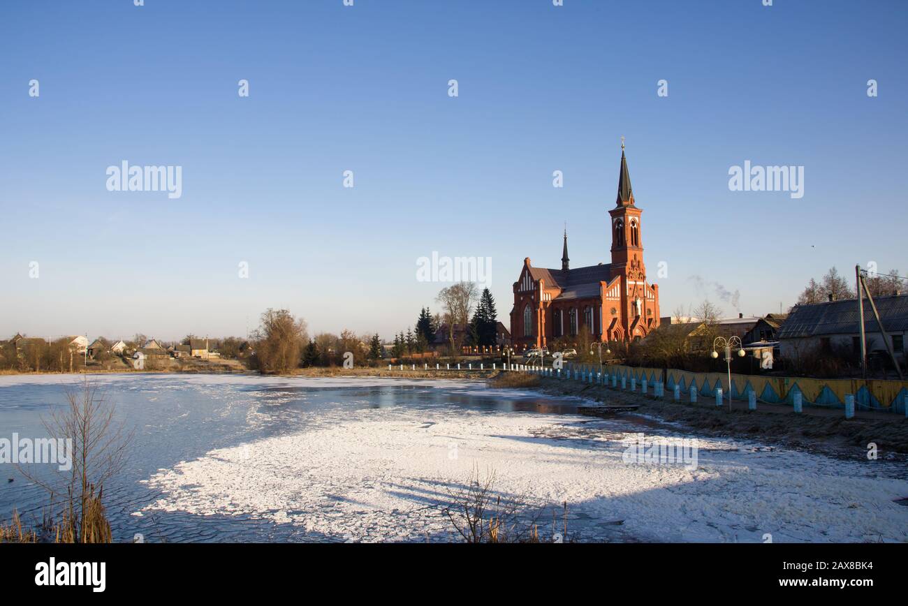 Catholic church on the river bank Stock Photo - Alamy