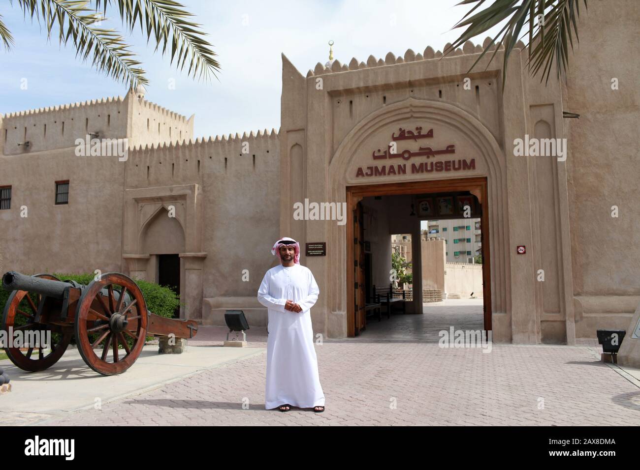 A man stands in front of the Ajman Museum. Ajman, UAE. Stock Photo