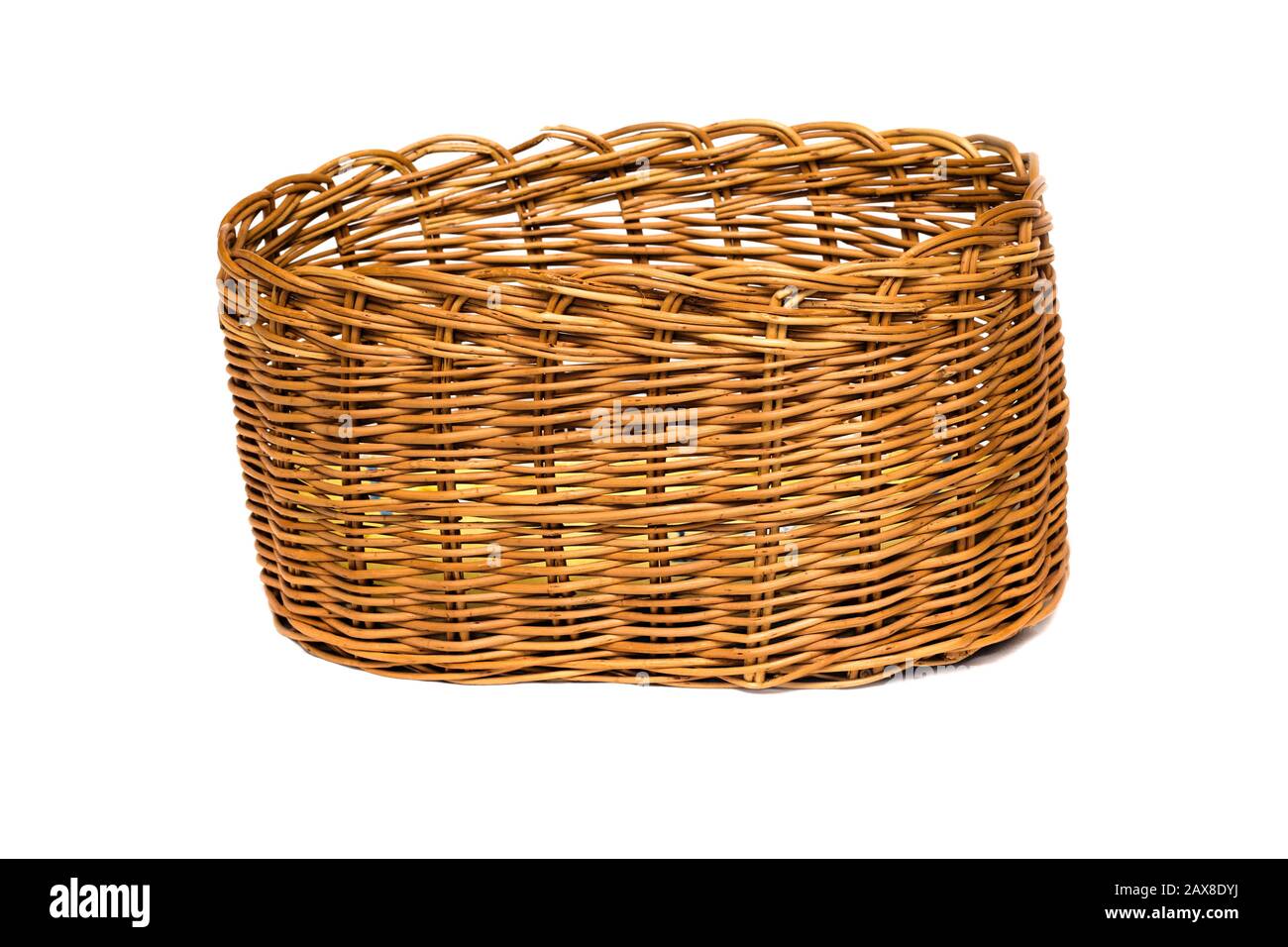 Yellow wicker basket made from a vine on a white background Stock Photo