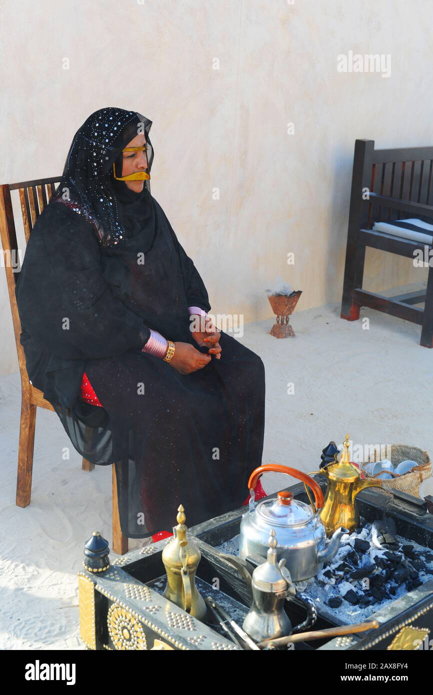 Arab woman with tea kettle at Qasr Al Hosn Festival, Abu Dhabi, United Arab Emirates. Stock Photo