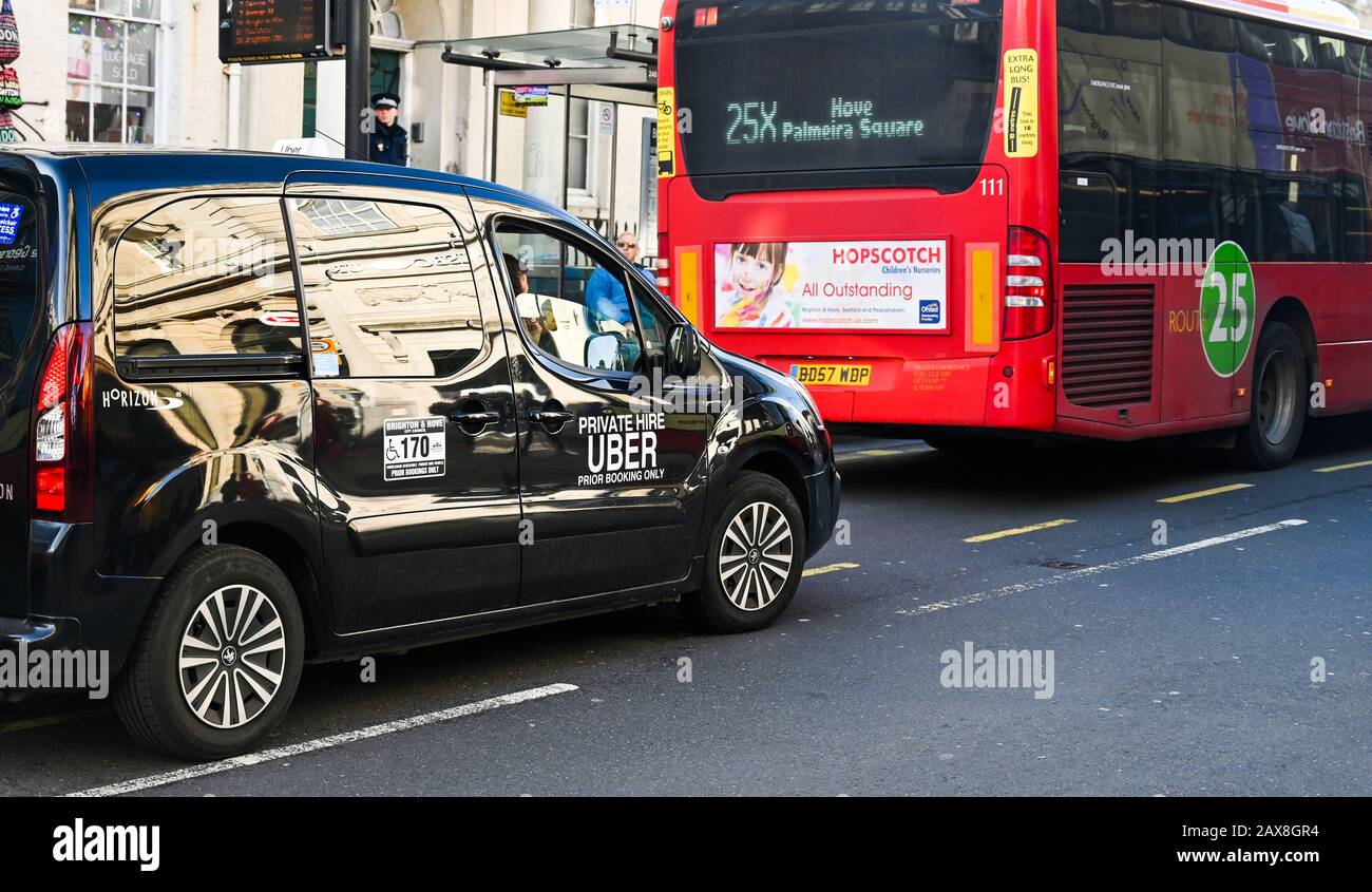 Uber taxi cab driving through Brighton East Sussex UK Stock Photo