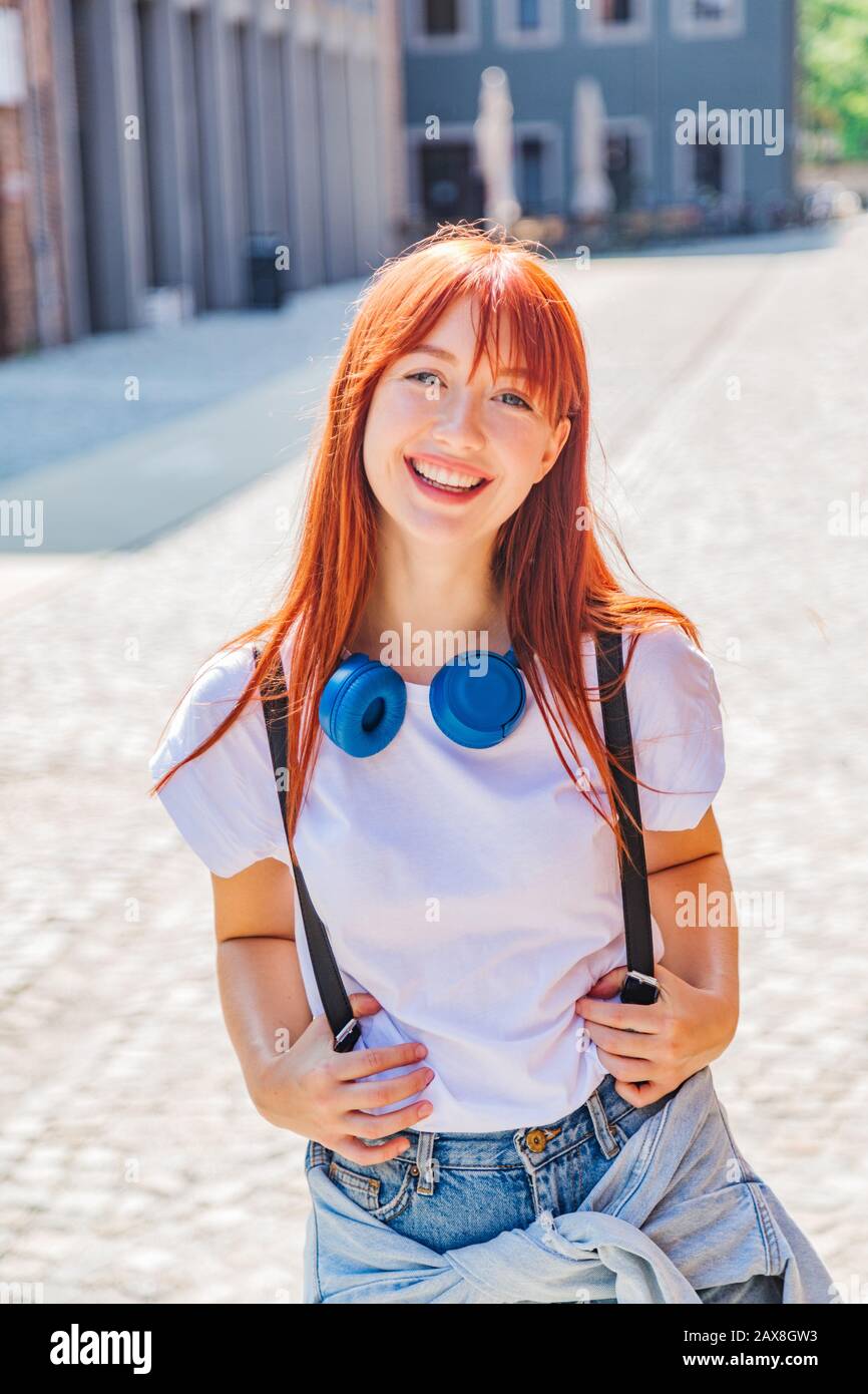 Cute redhead girl having fun on street near bikes Stock Photo - Alamy