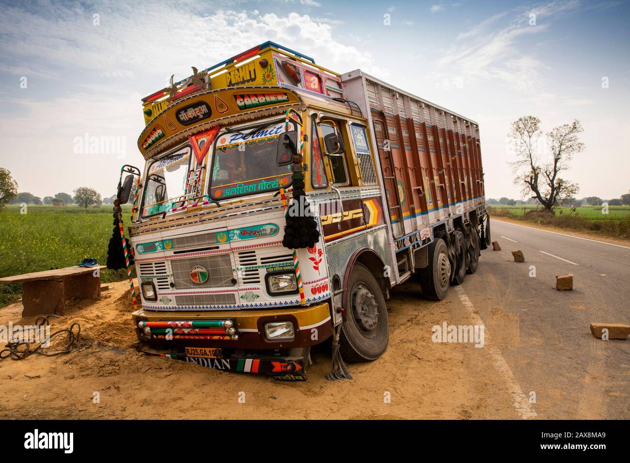 India, Rajasthan, Hindaun, truck up to axle in sand after running off road Stock Photo