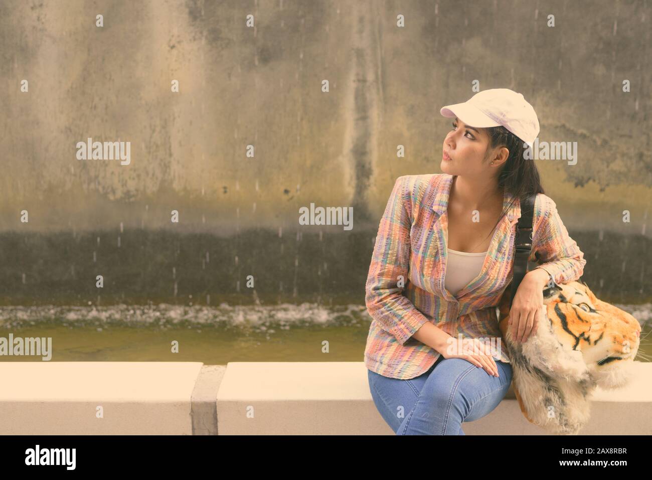 Young beautiful Asian tourist woman exploring the city Stock Photo