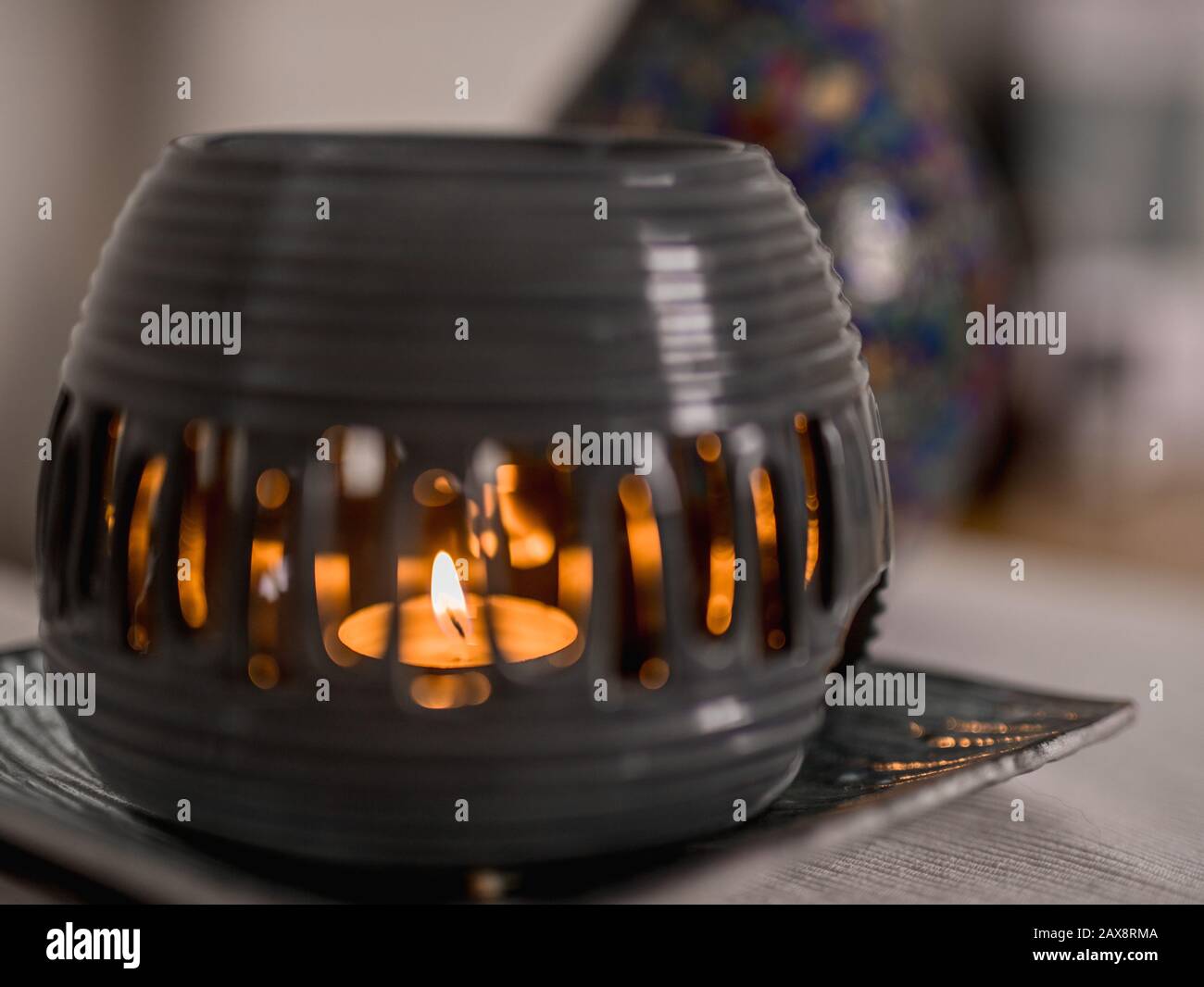 Aroma lamp with burning candle and essential oil on a plate. Spa room hotel Stock Photo Alamy