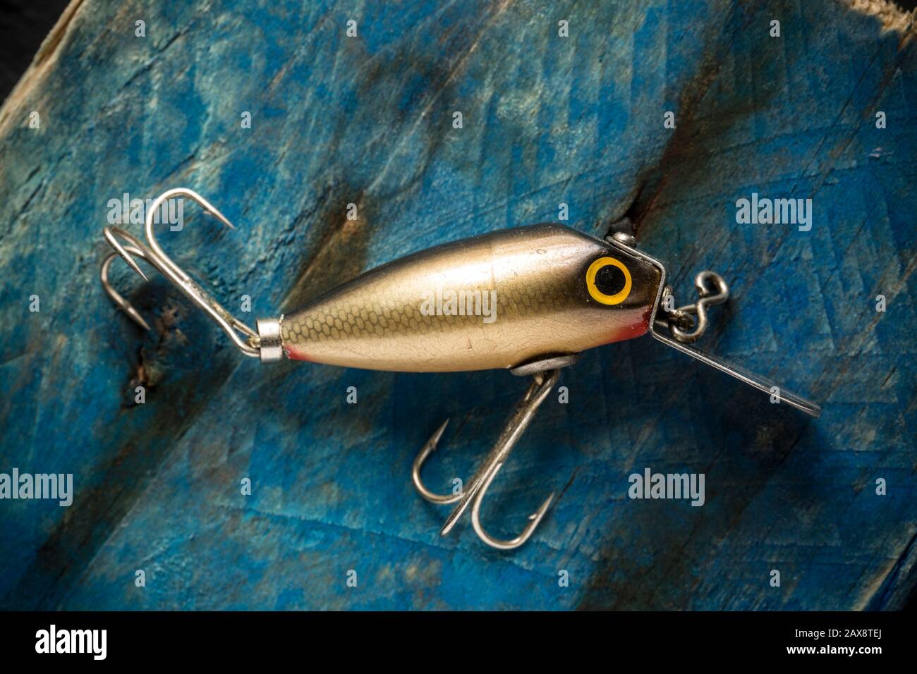 https://c8.alamy.com/comp/2AX8TEJ/an-old-fishing-lure-or-plug-equipped-with-treble-hooks-designed-to-catch-predatory-fish-the-lure-has-possibly-been-made-by-woods-mfg-but-this-cann-2AX8TEJ.jpg